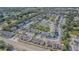 A vast aerial view showcases a well-planned community with townhouses, a tranquil lake, and mature trees at 6343 Osprey Lake Circle, Riverview, FL 33578