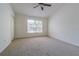 Bedroom featuring a ceiling fan, neutral carpeting, and a window with blinds at 6343 Osprey Lake Circle, Riverview, FL 33578