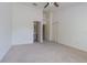Bright and airy bedroom leading to a bathroom and closets, with neutral carpet and modern ceiling fan at 6343 Osprey Lake Circle, Riverview, FL 33578