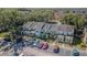 An aerial view shows townhouses surrounded by lush trees and well-maintained landscaping, with ample parking at 6343 Osprey Lake Circle, Riverview, FL 33578