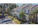 Well-maintained townhouse complex with manicured lawns, lush trees, and ample parking for residents and guests at 6343 Osprey Lake Circle, Riverview, FL 33578