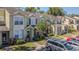 Townhome showcasing well-maintained landscaping and ample parking spaces at 6343 Osprey Lake Circle, Riverview, FL 33578