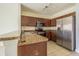 Functional kitchen with wooden cabinets, stainless steel appliances, and durable countertops for culinary enthusiasts at 6343 Osprey Lake Circle, Riverview, FL 33578