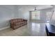 Cozy living room featuring ample natural light, tile flooring, and a comfortable seating area for relaxation at 6343 Osprey Lake Circle, Riverview, FL 33578