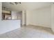 Open-concept living room featuring neutral tile flooring and white walls at 6343 Osprey Lake Circle, Riverview, FL 33578