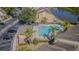 An aerial view shows a relaxing pool area with plenty of lounge chairs and mature palm trees at 6343 Osprey Lake Circle, Riverview, FL 33578
