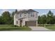 Charming two-story home with gray siding, an attached garage, and well-manicured front lawn at 6508 Top Hill Dr, New Port Richey, FL 34655
