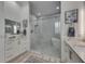 Bathroom showcasing a glass-enclosed shower, soaking tub and double vanities at 718 Manns Harbor Dr, Apollo Beach, FL 33572