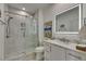Modern bathroom featuring a glass-enclosed shower and a marble vanity at 718 Manns Harbor Dr, Apollo Beach, FL 33572