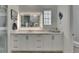 Modern bathroom featuring a large mirror with vanity and lighting at 718 Manns Harbor Dr, Apollo Beach, FL 33572