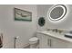 Charming powder room with attractive mirror, lighting, and artistic decor at 718 Manns Harbor Dr, Apollo Beach, FL 33572