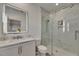Modern bathroom showcasing a glass shower, sleek vanity, and marble-style tile at 718 Manns Harbor Dr, Apollo Beach, FL 33572