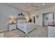 Bright primary bedroom featuring a tufted headboard and modern decor at 718 Manns Harbor Dr, Apollo Beach, FL 33572