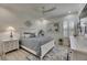 Nautical-themed bedroom with plantation shutters, ceiling fan, and white furniture at 718 Manns Harbor Dr, Apollo Beach, FL 33572