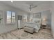 Well-lit bedroom with a ceiling fan, decorative rug, and large windows at 718 Manns Harbor Dr, Apollo Beach, FL 33572