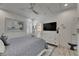 Bedroom featuring a ceiling fan and white dresser with decor and a view into the bathroom at 718 Manns Harbor Dr, Apollo Beach, FL 33572