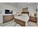 Bright bedroom with a ceiling fan, a wood bed frame and a television on the wall at 718 Manns Harbor Dr, Apollo Beach, FL 33572