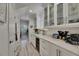 Elegant butler's pantry with white cabinetry, wine cooler, and stylish countertops, perfect for entertaining at 718 Manns Harbor Dr, Apollo Beach, FL 33572