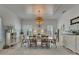 Elegant dining room featuring wainscoting, a coffered ceiling, and a unique pendant light fixture at 718 Manns Harbor Dr, Apollo Beach, FL 33572