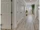 Bright hallway with wood-look floors, white trim, and plenty of natural light from the window at 718 Manns Harbor Dr, Apollo Beach, FL 33572