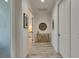 Hallway with decor leading to a bedroom with white furnishings and light at 718 Manns Harbor Dr, Apollo Beach, FL 33572