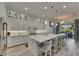 Bright, modern kitchen with quartz countertops, large island and views to the outside patio at 718 Manns Harbor Dr, Apollo Beach, FL 33572