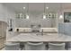 Spacious kitchen with an island featuring a waterfall countertop and pendant lighting at 718 Manns Harbor Dr, Apollo Beach, FL 33572