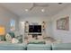 Cozy living room featuring comfortable seating, decorative pillows, and stylish entertainment center at 718 Manns Harbor Dr, Apollo Beach, FL 33572