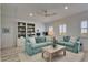 Cozy living room with light blue couches, a ceiling fan and a decorative bookshelf at 718 Manns Harbor Dr, Apollo Beach, FL 33572