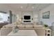 Bright living room featuring a ceiling fan, fireplace and modern decor at 718 Manns Harbor Dr, Apollo Beach, FL 33572