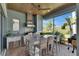 Outdoor kitchen with stainless steel appliances, bar seating, and wood-paneled ceiling at 718 Manns Harbor Dr, Apollo Beach, FL 33572
