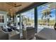 Relaxing outdoor patio with comfortable seating, overlooking the pool and lush landscaping at 718 Manns Harbor Dr, Apollo Beach, FL 33572