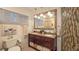 Well-lit bathroom featuring double sinks, a vanity with granite countertop, and decorative mirrors at 7301 2Nd S Ave, St Petersburg, FL 33707