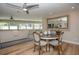 Open dining area features a round table, hardwood floors, and flows into the living room at 7301 2Nd S Ave, St Petersburg, FL 33707