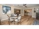 Spacious dining room with modern art, chandelier, and hardwood floors leading into the kitchen at 7301 2Nd S Ave, St Petersburg, FL 33707