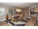 Well-lit dining area showcasing a large wooden table, decorative lighting, and an accent wall, adjacent to the modern kitchen at 7301 2Nd S Ave, St Petersburg, FL 33707