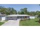 Well maintained home featuring a lush lawn, flowers, and a beautiful stone exterior at 7301 2Nd S Ave, St Petersburg, FL 33707