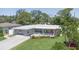 Inviting home featuring a stone facade, beautiful landscaping, and an inviting porch at 7301 2Nd S Ave, St Petersburg, FL 33707