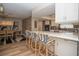 Bright kitchen featuring white cabinetry, stainless steel appliances, stone countertops, and bar seating at 7301 2Nd S Ave, St Petersburg, FL 33707