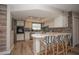 Updated kitchen showcases light wood floors, stone countertops, stainless appliances, and lots of cabinets at 7301 2Nd S Ave, St Petersburg, FL 33707