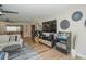 Bright living room featuring hardwood floors, entertainment center and a modern ceiling fan at 7301 2Nd S Ave, St Petersburg, FL 33707
