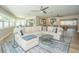Open living area features hardwood floors, a comfortable sofa, large rug, and plenty of windows at 7301 2Nd S Ave, St Petersburg, FL 33707