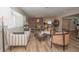 Bright, open-concept living room with hardwood floors, modern furniture, and seamless flow into the dining and kitchen areas at 7301 2Nd S Ave, St Petersburg, FL 33707