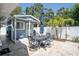 Outdoor patio area with seating, dining, and a well-maintained shed with palm trees at 7301 2Nd S Ave, St Petersburg, FL 33707