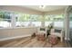 Relaxing sunroom with large windows overlooking the private yard with lots of plants at 7301 2Nd S Ave, St Petersburg, FL 33707