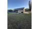 Large backyard featuring a screened-in patio and exterior AC unit at 7601 Como Dr, New Port Richey, FL 34655