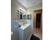 Bathroom featuring a vanity with modern faucet, neutral colors, and tile accents at 7601 Como Dr, New Port Richey, FL 34655