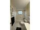 A well-lit bathroom featuring a tub-shower combo with white tile and a functional toilet at 7601 Como Dr, New Port Richey, FL 34655