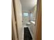 Bathroom featuring a shower-tub combo, single sink vanity, tile floors, and a grey rug at 7601 Como Dr, New Port Richey, FL 34655