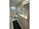 Bathroom featuring a shower-tub combo and a white single sink vanity with a large mirror at 7601 Como Dr, New Port Richey, FL 34655